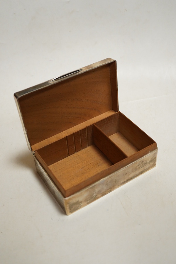 A George V silver table cigarette box with engine turned lid, London, 1924, makers mark rubbed, cedar lined with division, initialled length 14cm.